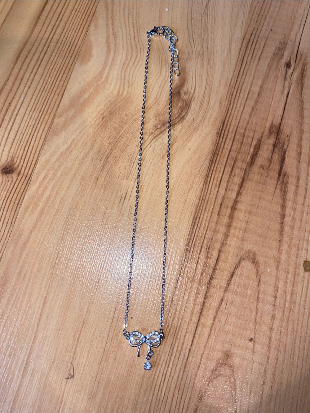Silver Bow Pendant Necklace with Crystal Drop